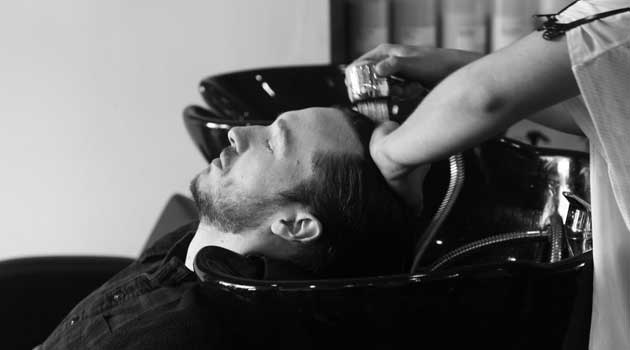 Men having his hair washed before a haircut Men having his hair washed before a haircut