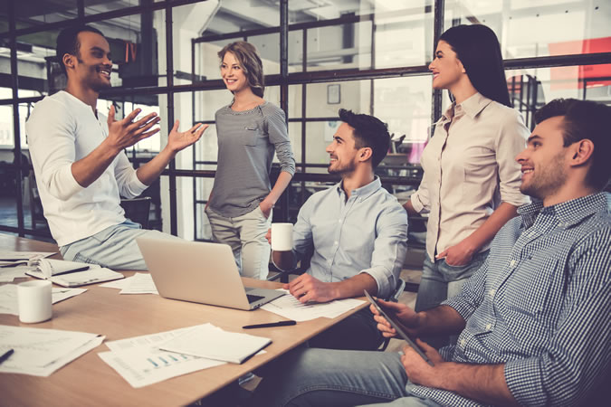 A Manager Speaking To Colleagues At An Office