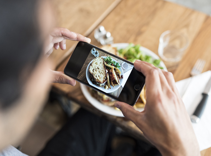 Someone Taking A Photo Of Their Food