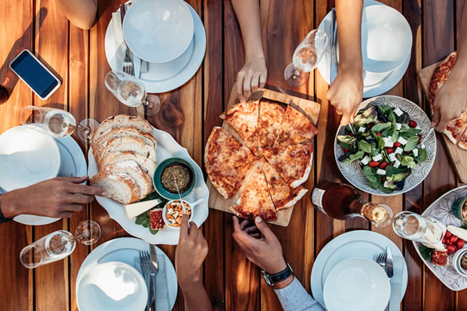 People sharing a pizza