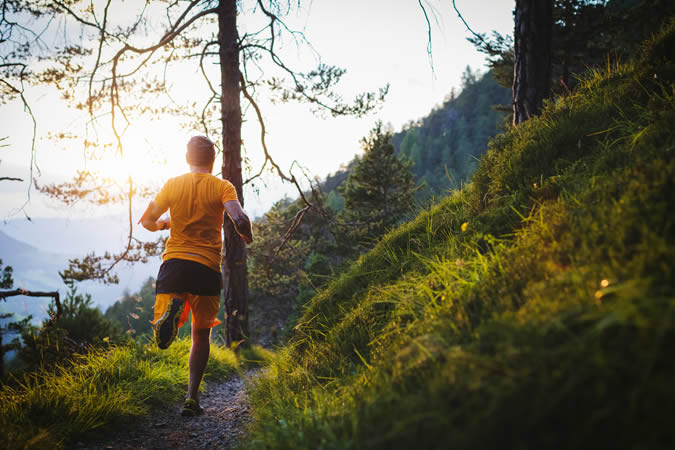 Man running on a hill path