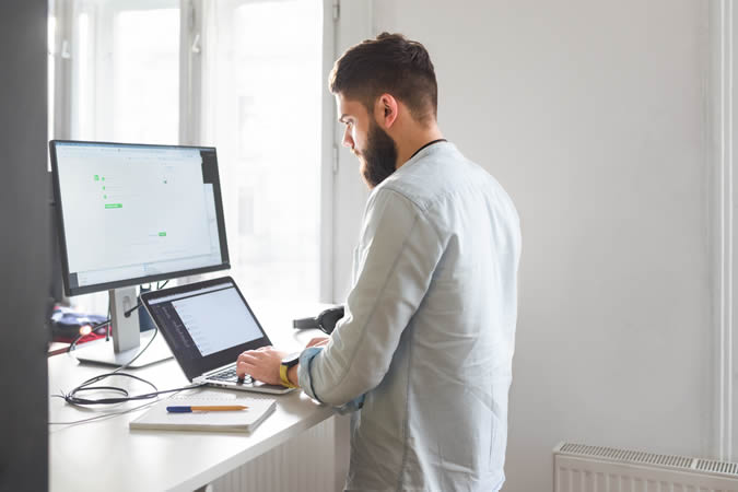 Man working at a standing desk